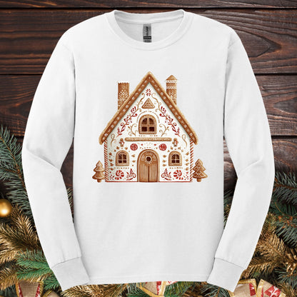 White Gildan long sleeve tee with a folk art gingerbread house design in watercolor tones.