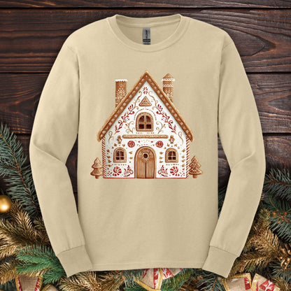Sand Gildan long sleeve tee with a folk art gingerbread house design in watercolor tones.