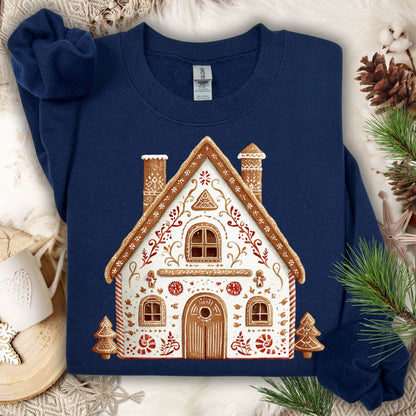 Navy Gildan sweatshirt with a folk art gingerbread house design, surrounded by festive decor.