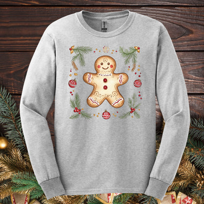 Ash long sleeve tee with a folk art gingerbread man, pine sprigs, and ornaments.