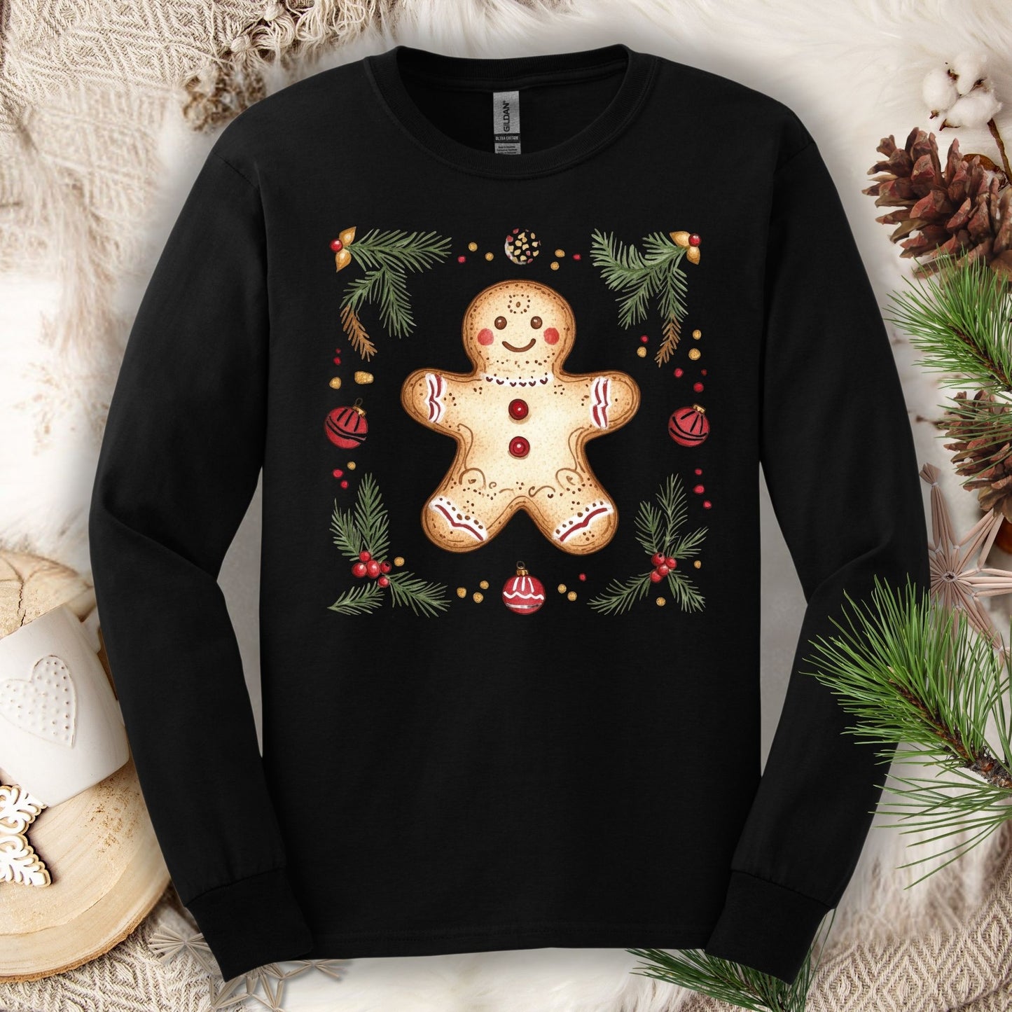 Black long sleeve tee with a hand-painted gingerbread man, pine sprigs, and ornaments.