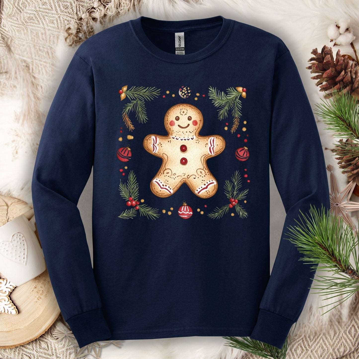 Navy long sleeve tee with a hand-painted gingerbread man, pine sprigs, and ornaments.