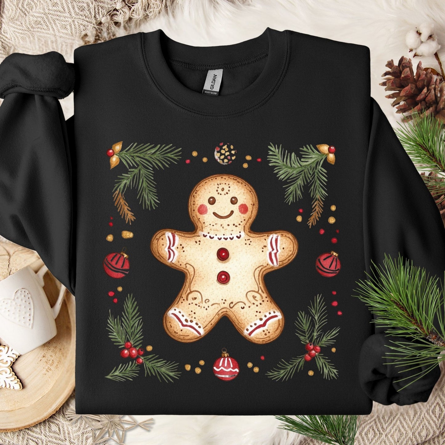 Black Gildan sweatshirt with folk art gingerbread man, holly, and evergreen design.