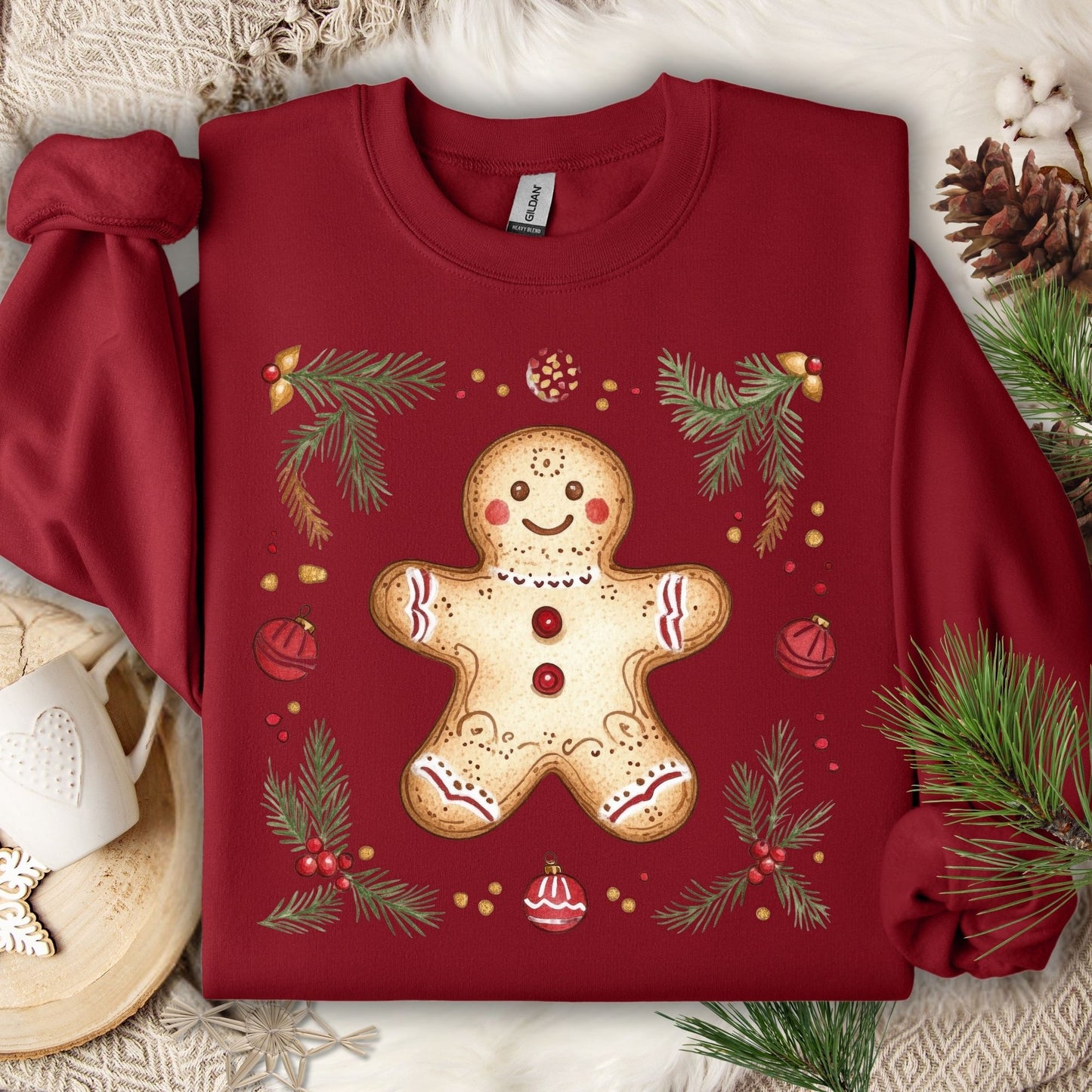 Cardinal Red Gildan sweatshirt with a folk art gingerbread man, holly, and evergreen design.