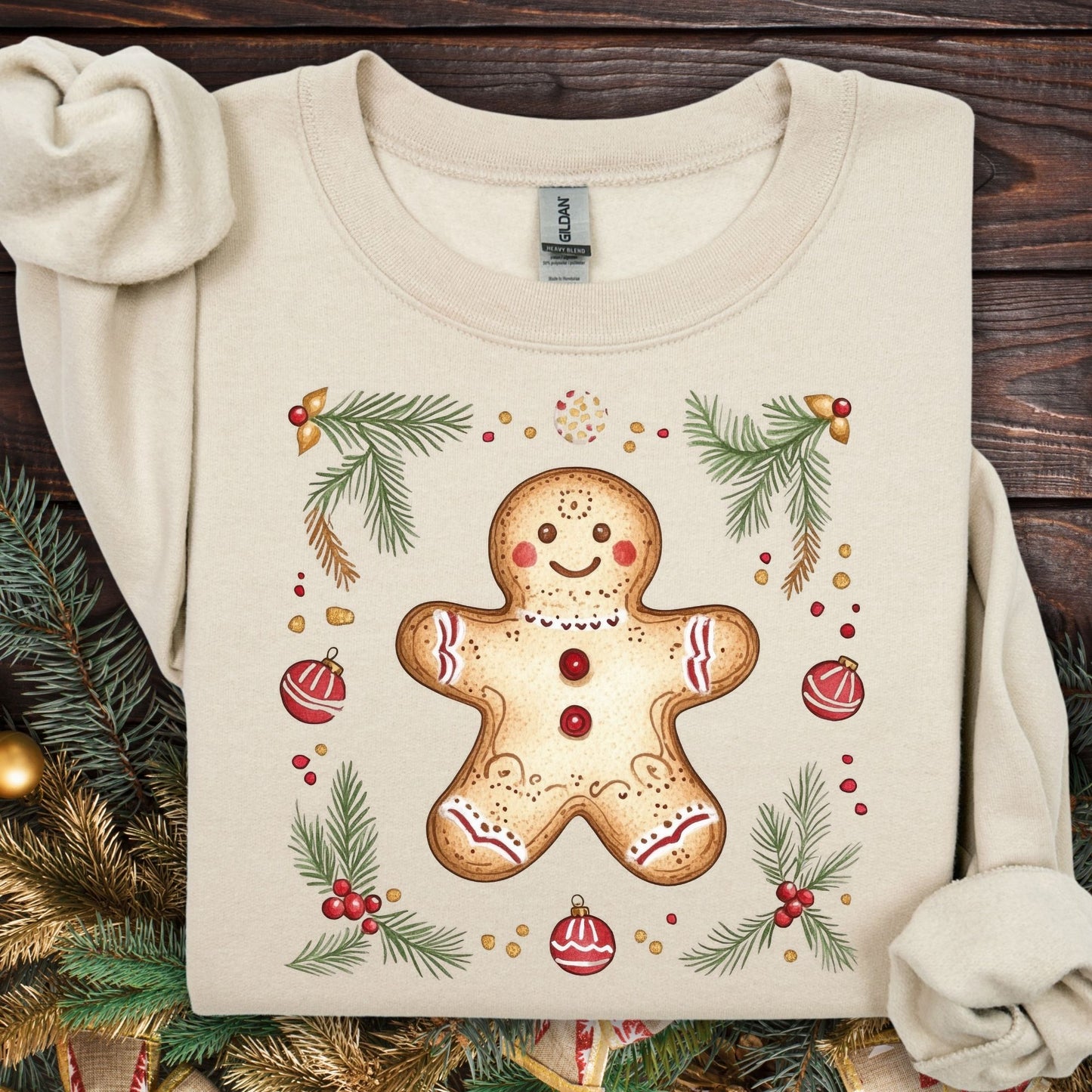 Sand Gildan sweatshirt with folk art gingerbread man, holly, and evergreen design.