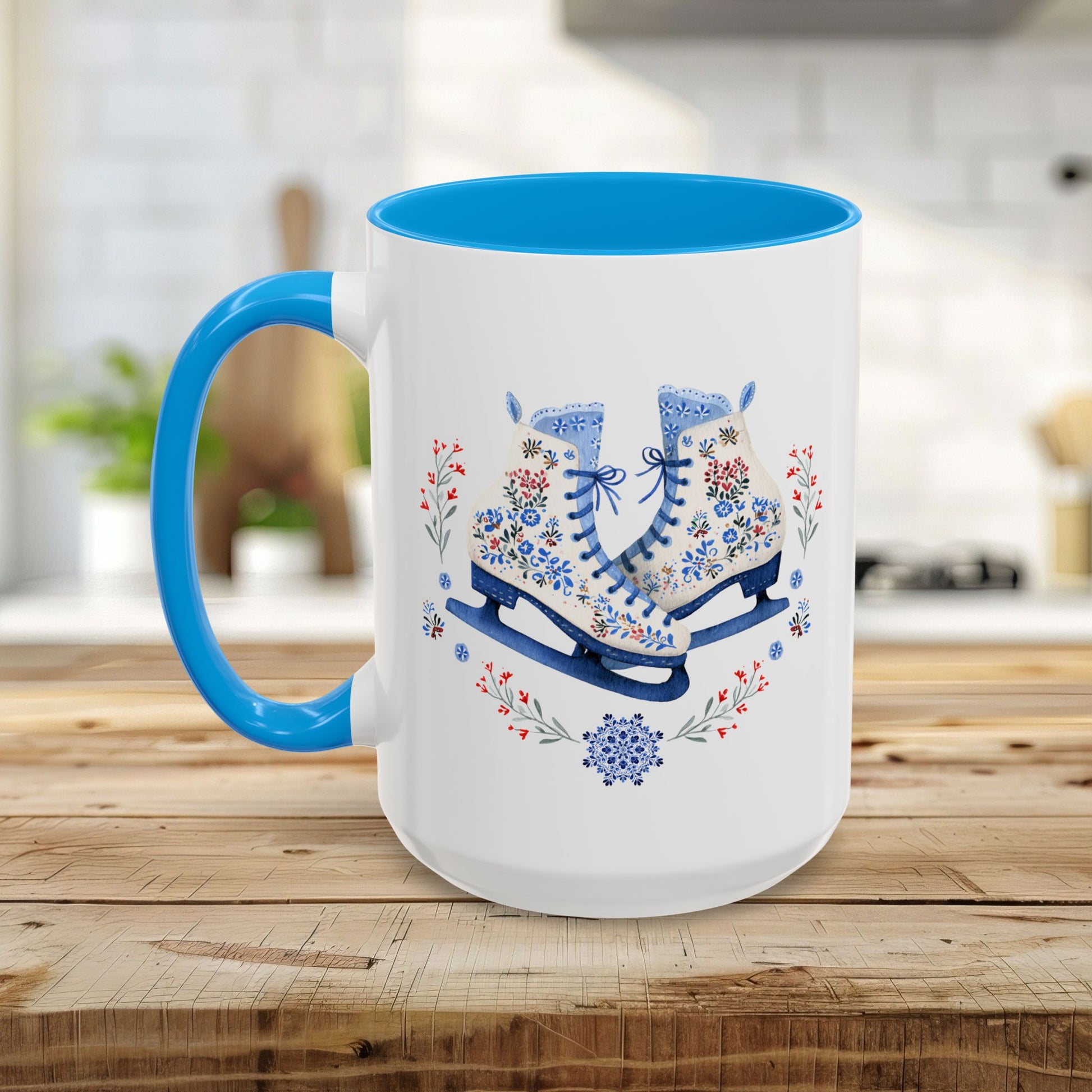 White ceramic mug with blue handle and interior, featuring folk art ice skates, snowflakes, and winter berries.