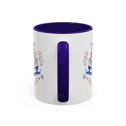 White ceramic mug with a navy blue interior and handle, featuring a folk art ice skate design.