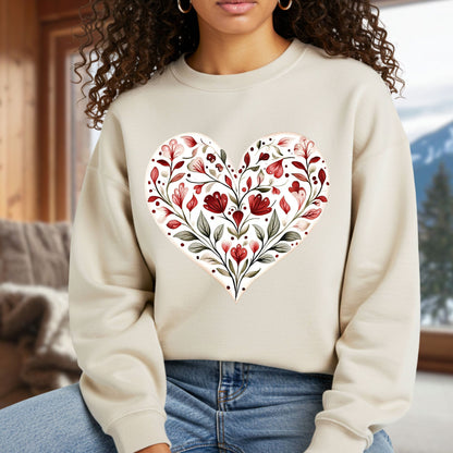 Beige sweatshirt with a red floral folk art heart design, worn by a person.