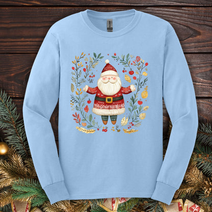 Light blue Gildan long sleeve tee with a folk art Santa in a wreath of evergreen, holly, and berries.