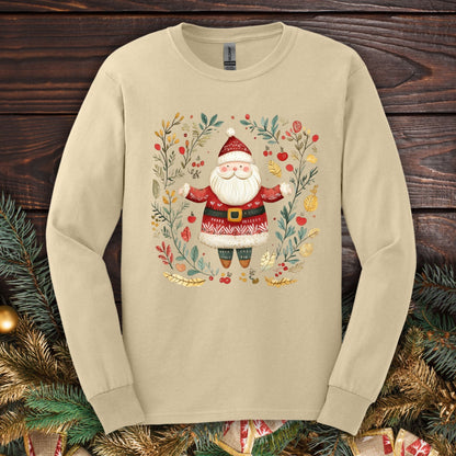 Sand Gildan Softstyle long sleeve tee with folk art Santa in a festive wreath of evergreen, holly, and berries.
