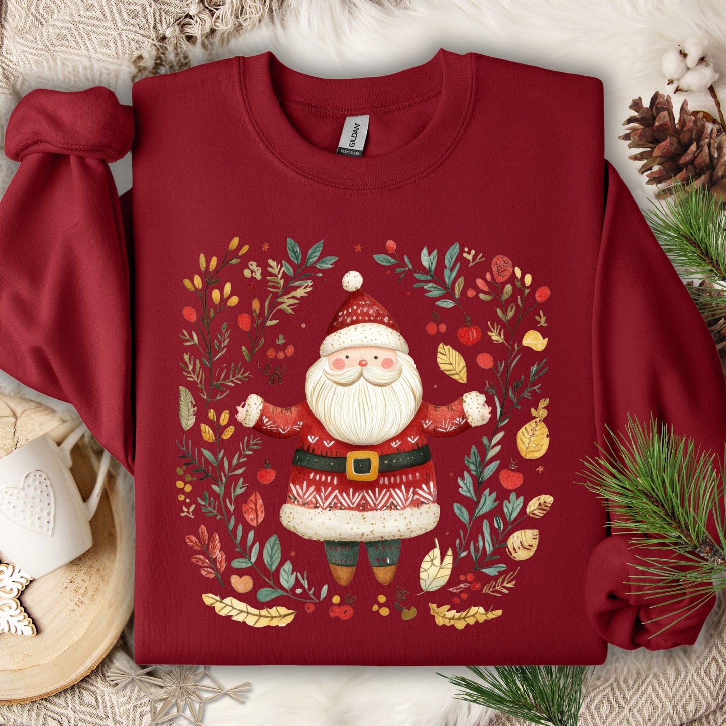 Cardinal Red Folk Art Santa Wreath Sweatshirt, featuring a detailed Santa in a wreath of evergreens, holly, and golden accents.