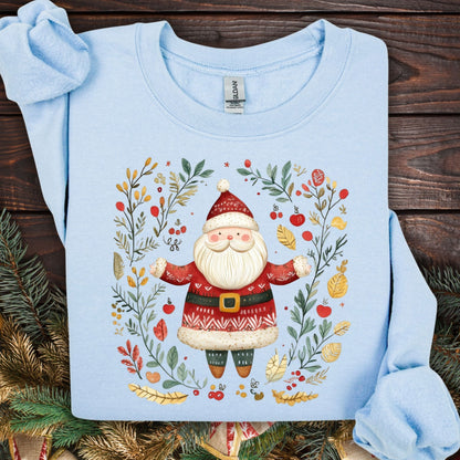 Light blue midweight fleece sweatshirt with folk art Santa in a wreath of evergreens, holly, and golden accents.