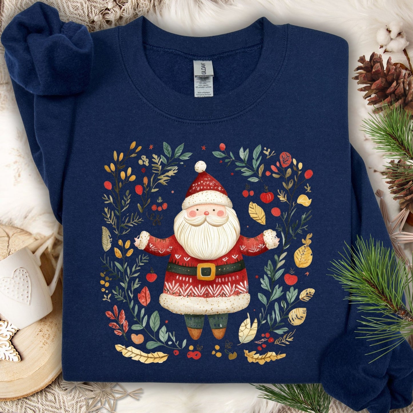Navy midweight fleece sweatshirt with folk art Santa in an evergreen, holly, and golden wreath design.
