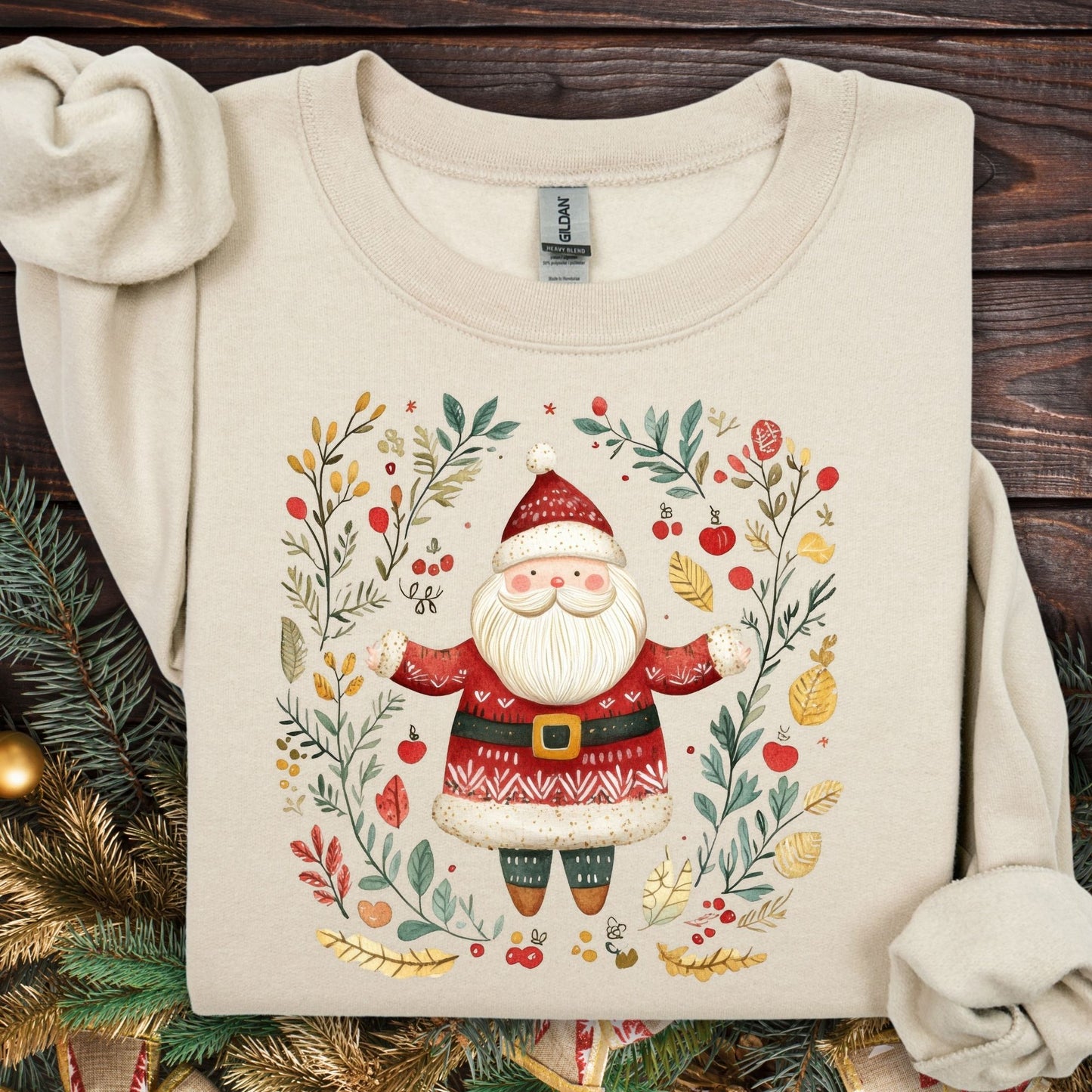 Sand midweight fleece sweatshirt with folk art Santa in a wreath of evergreens, holly, and golden accents.