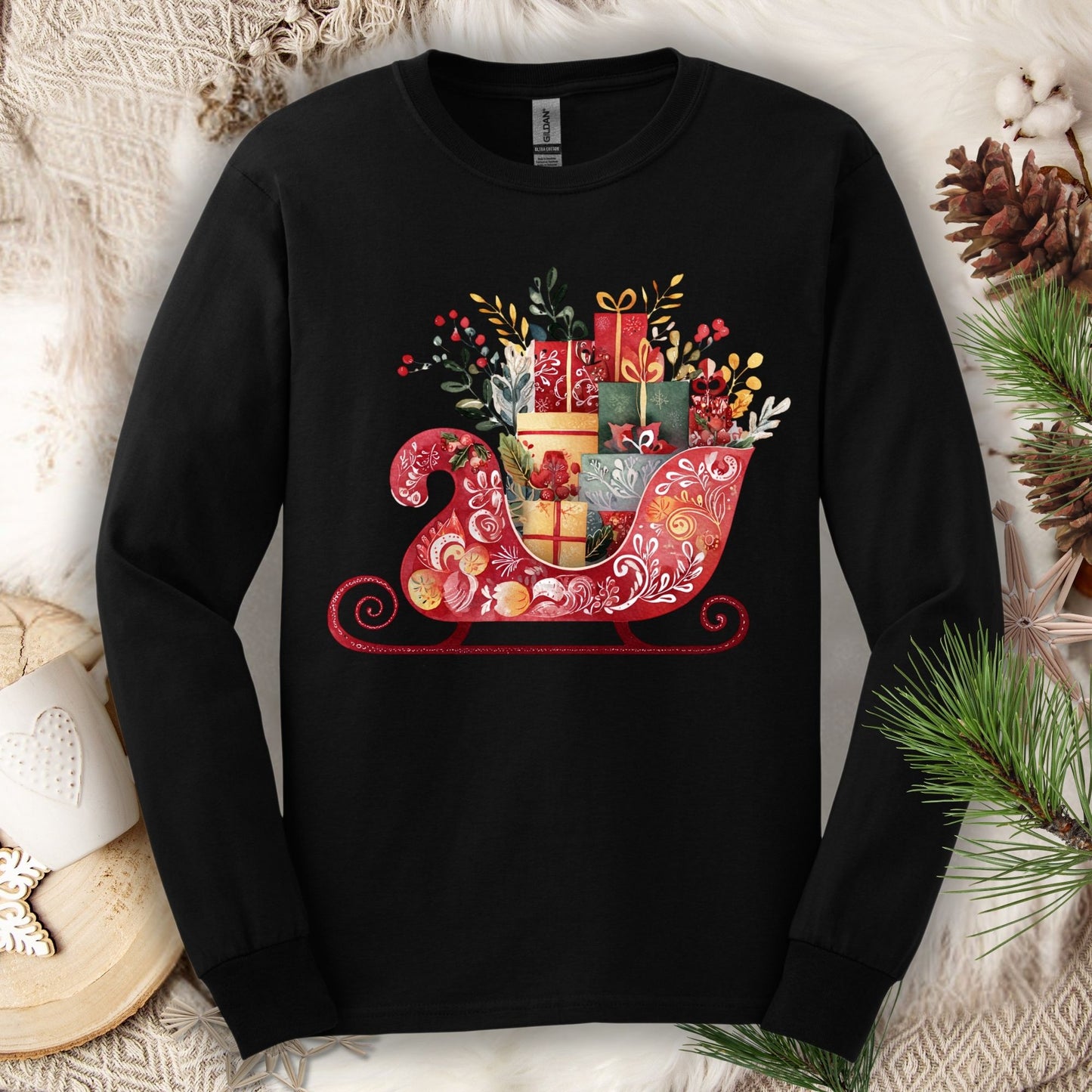 Black Gildan long sleeve tee with a folk art Old World Christmas sleigh design, brimming with festive gifts.