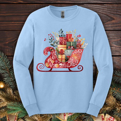 Light blue Gildan long sleeve tee with a folk art Old World Christmas sleigh design, brimming with gifts.