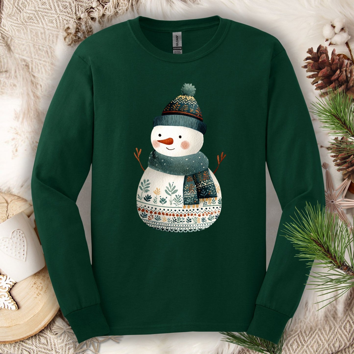 Forest Green Gildan long sleeve tee with a folk art snowman in a teal hat and scarf.