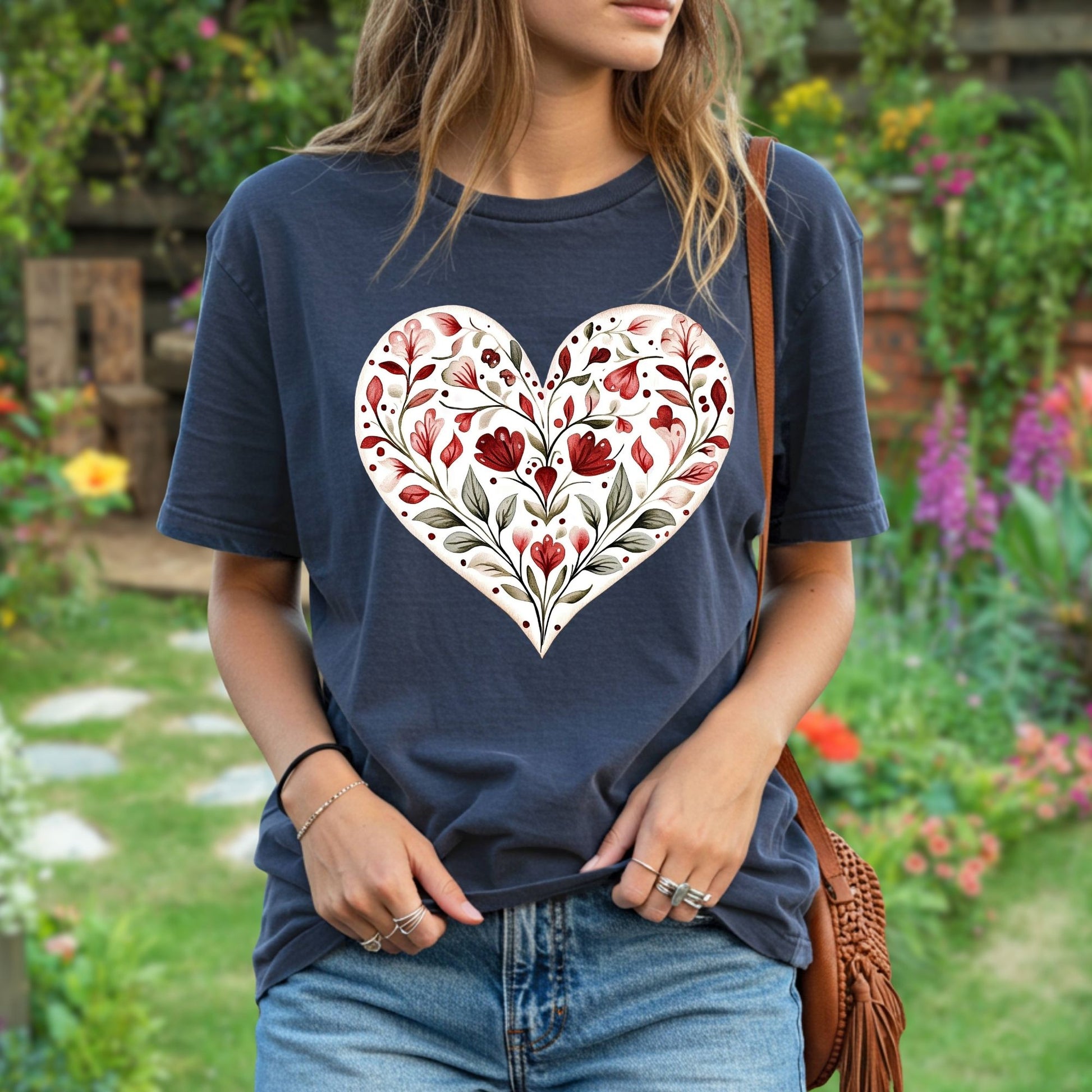 Relaxed-fit navy t-shirt with a painterly red and green folk floral heart design.