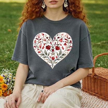 Relaxed-fit, garment-dyed charcoal t-shirt with a red floral heart design, worn by a person on a picnic blanket.