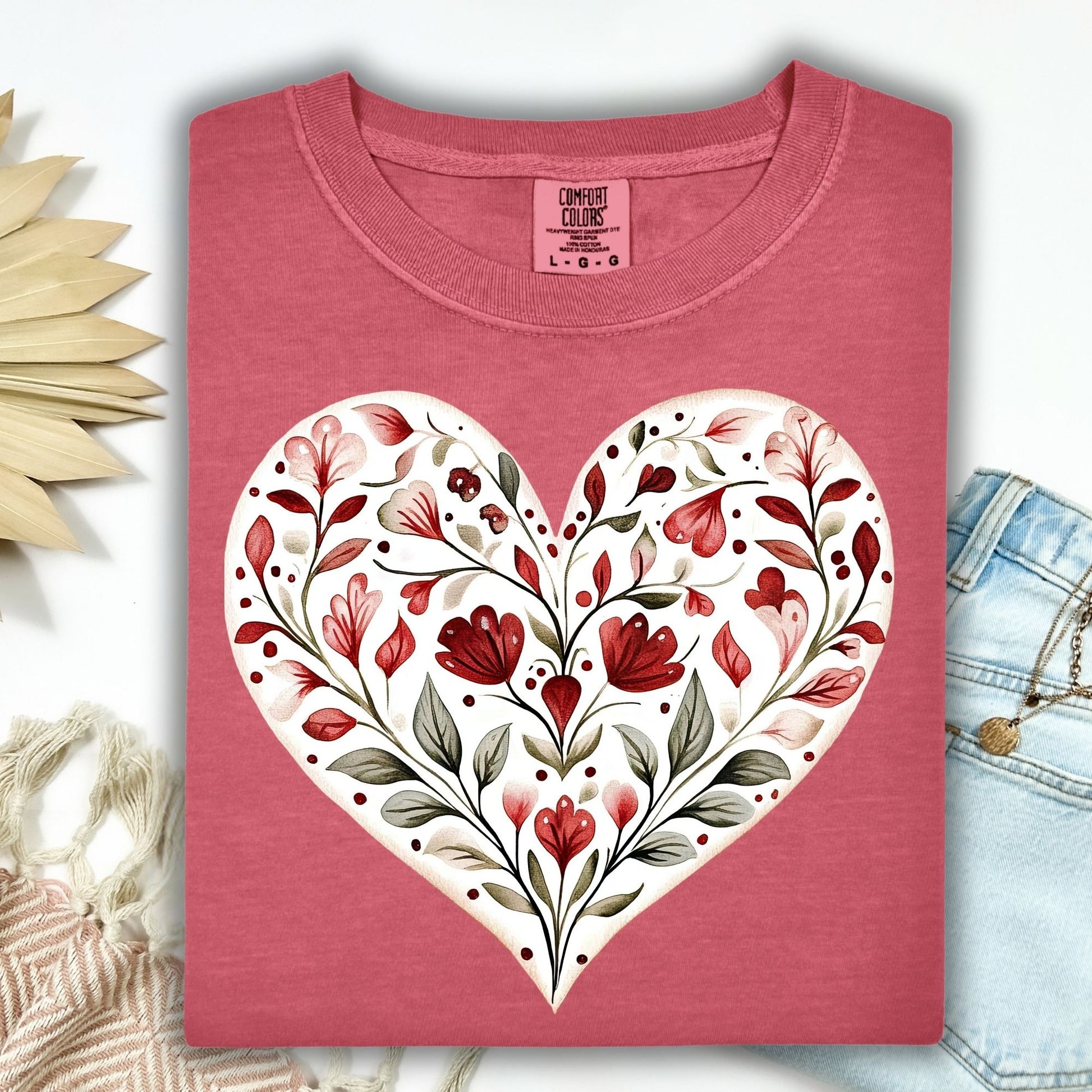 Crimson S t-shirt with a painterly folk art floral heart in red and green.