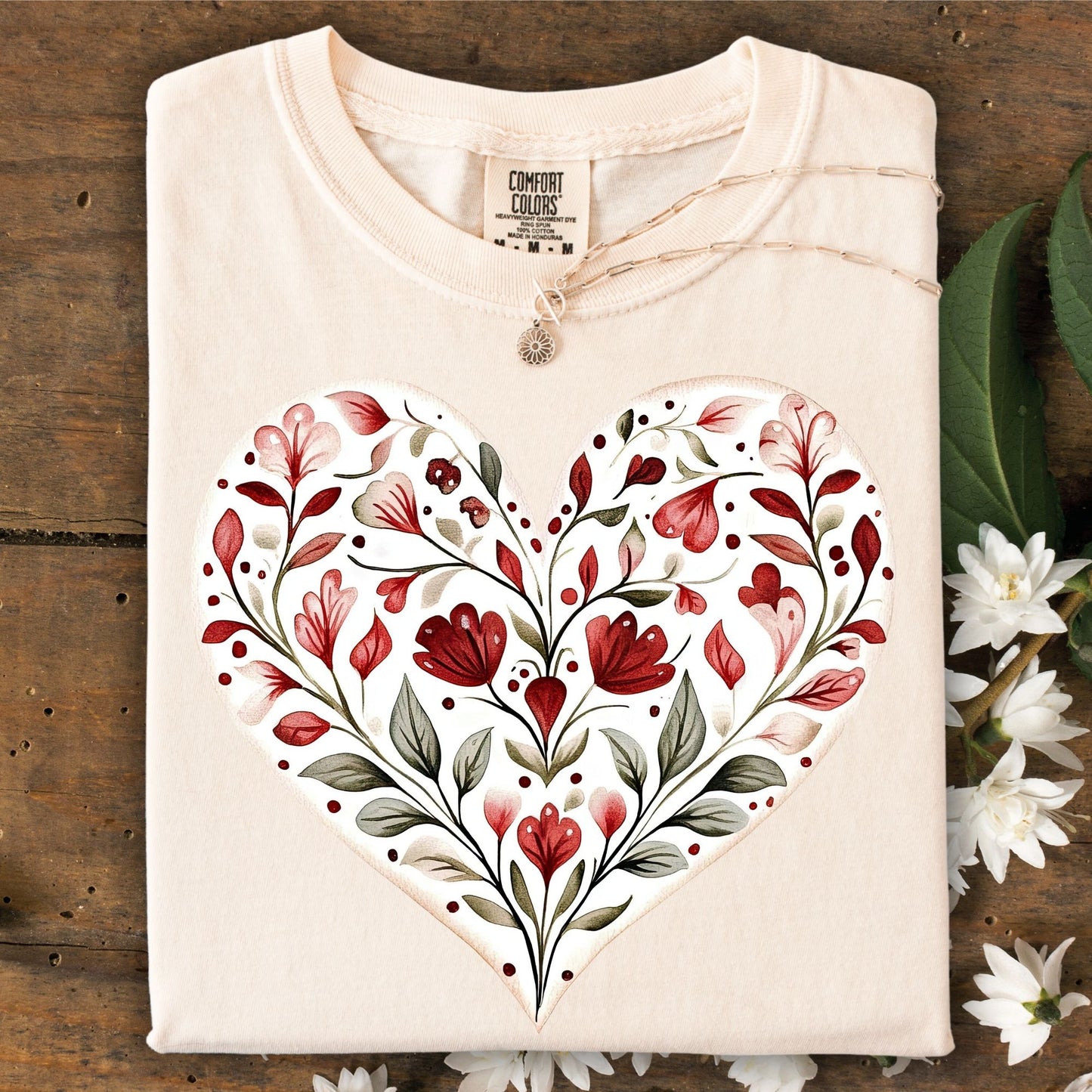 Ivory S t-shirt with a red floral heart design, made from 100% ring-spun cotton.