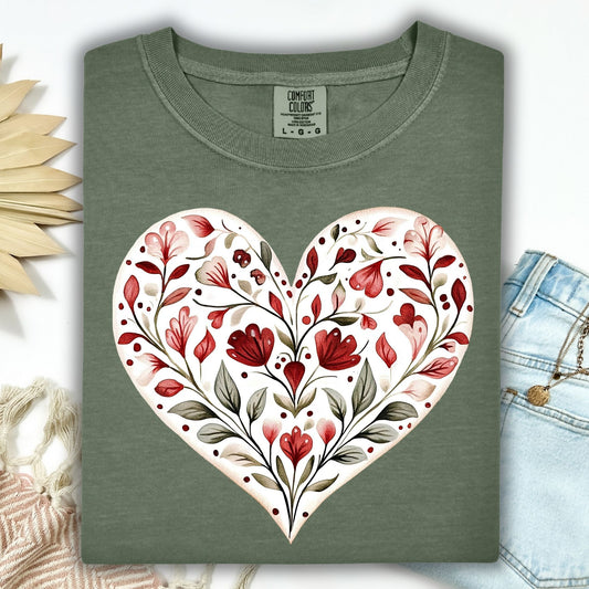 Moss green relaxed-fit t-shirt with a large folk art red floral heart design.