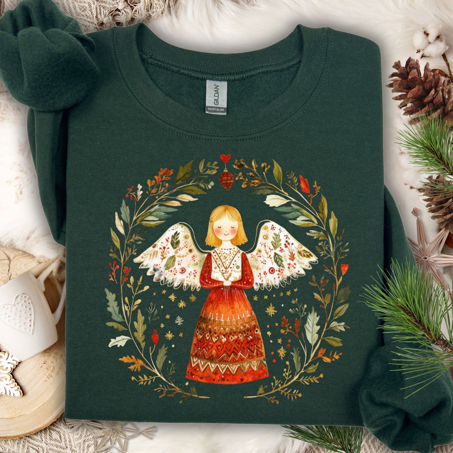 Forest Green sweatshirt with a folk art angel in a winter wreath, featuring red, green, and golden hues.