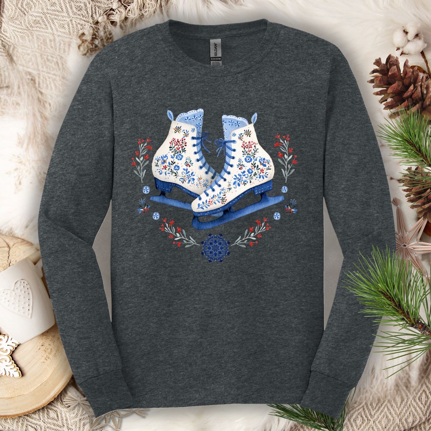 Dark Heather long sleeve tee with folk art winter ice skates in blues, reds, and whites, surrounded by florals.