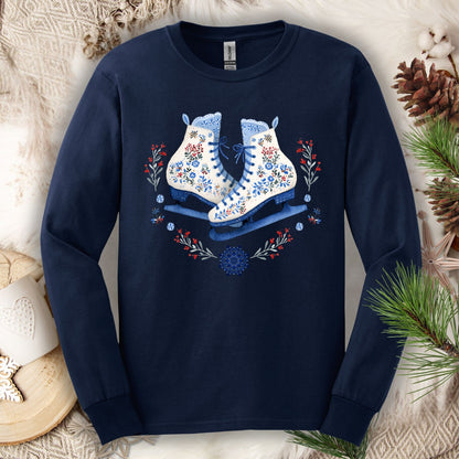 Navy long sleeve tee with folk art winter ice skates in blues, berry reds, and white floral details.