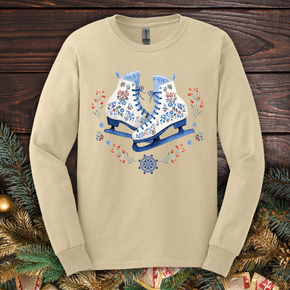 Sand long sleeve tee with folk art winter ice skates in blue, red, and white floral designs.