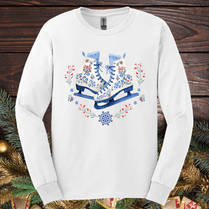 White long sleeve tee with folk art winter ice skates in blue, red, and white floral designs.