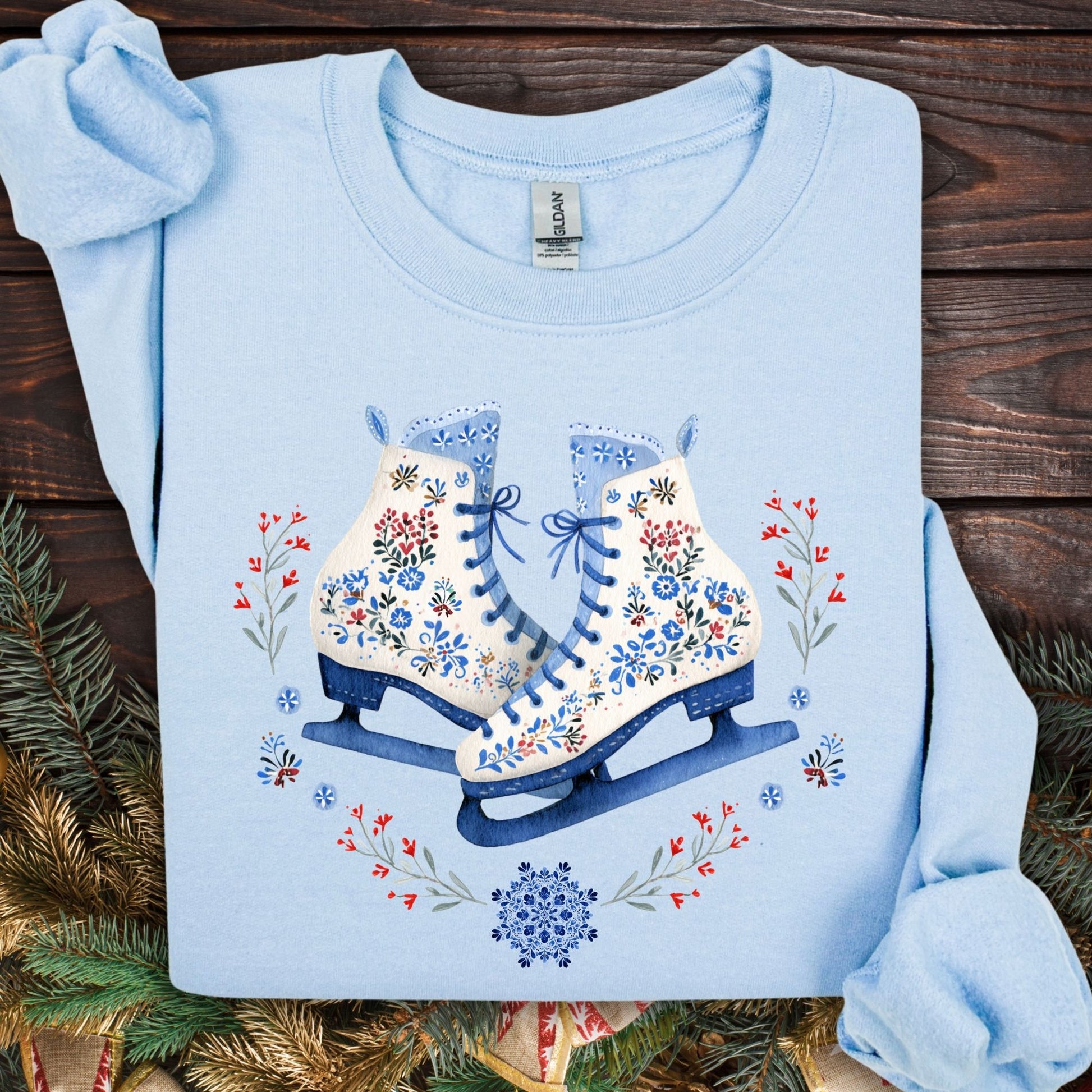 Light blue heavyweight fleece sweatshirt with folk art ice skates design in blue, white, and red.