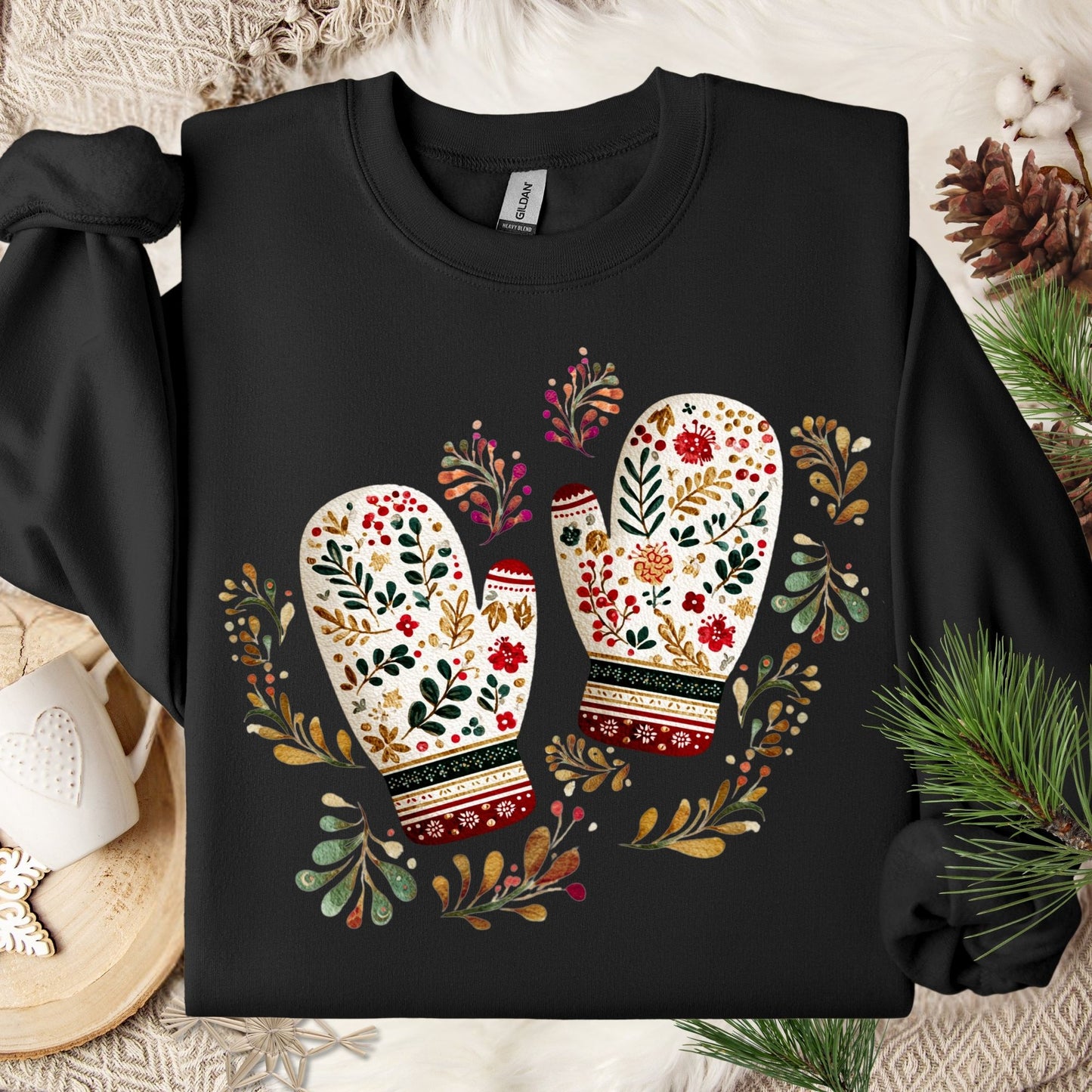 Black crewneck sweatshirt with folk art mittens, florals, and pine sprigs.