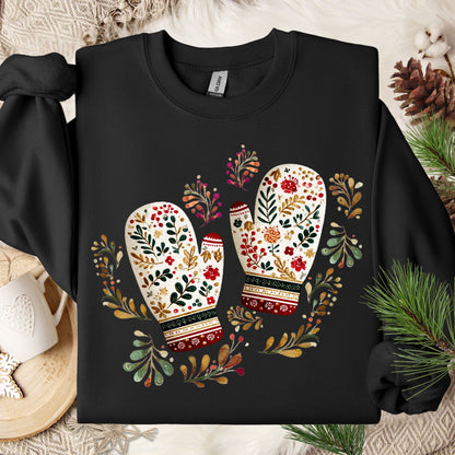 Black crewneck sweatshirt with folk art mittens, florals, and pine sprigs.