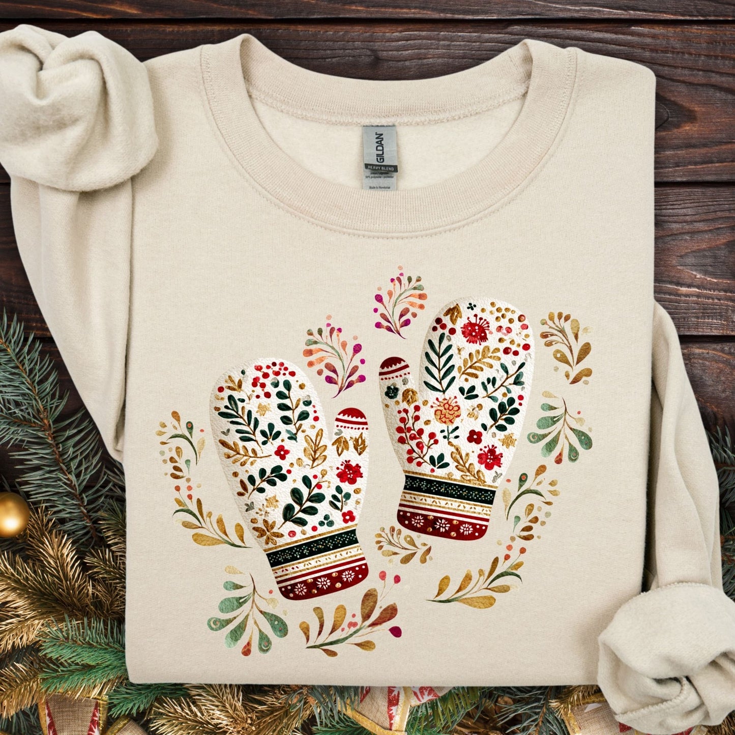 Sand crewneck sweatshirt with folk art mittens, florals, and pine sprigs.