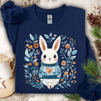 Navy Folk Art Winter Rabbit sweatshirt with a white bunny in a blue sweater, surrounded by floral designs.