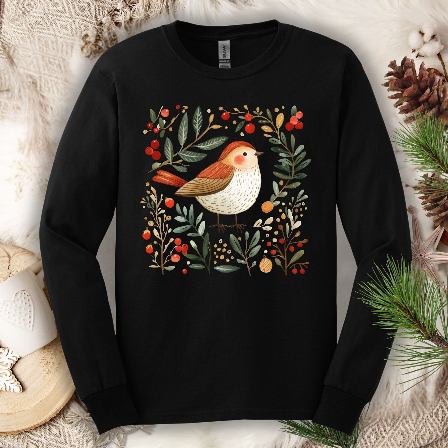 Black Gildan Softstyle long sleeve tee with a folk art winter sparrow, evergreens, holly, and ornaments.