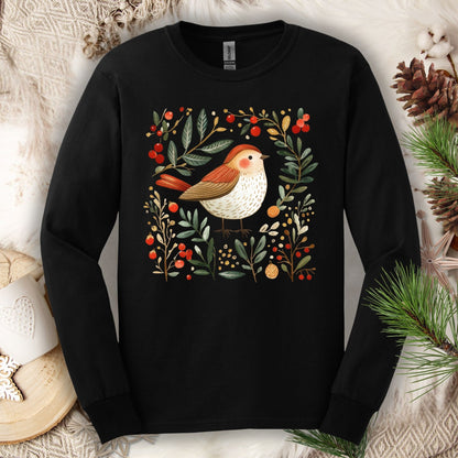 Black Gildan Softstyle long sleeve tee with a folk art winter sparrow, evergreens, holly, and ornaments.