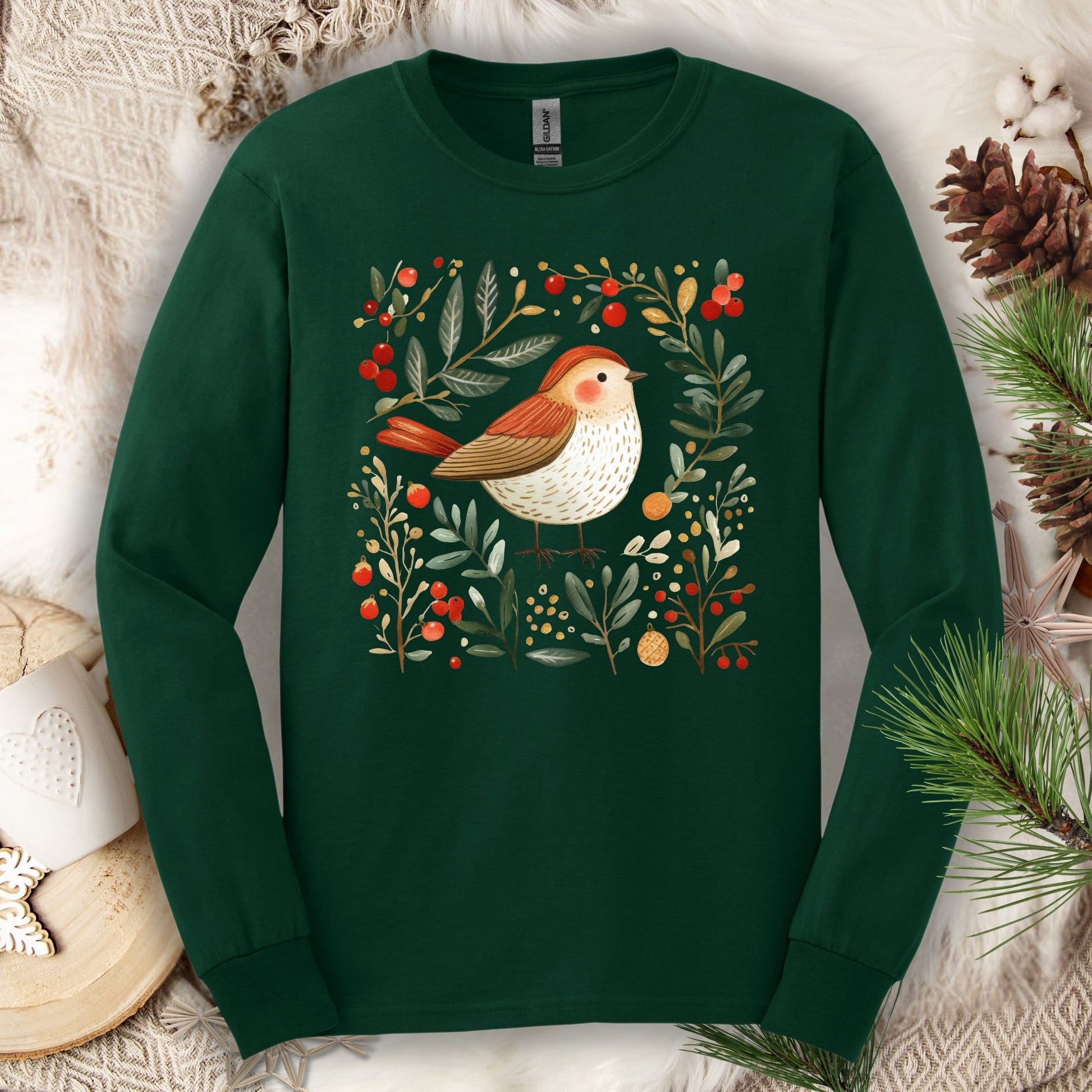 Forest Green Gildan Softstyle long sleeve tee with folk art winter sparrow, evergreens, holly, and ornaments.