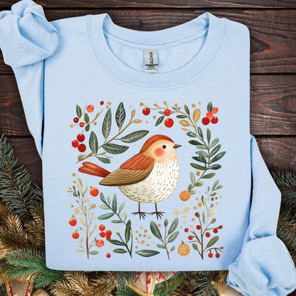 Light blue folk art winter sparrow sweatshirt with red berries, green leaves, and gold accents.