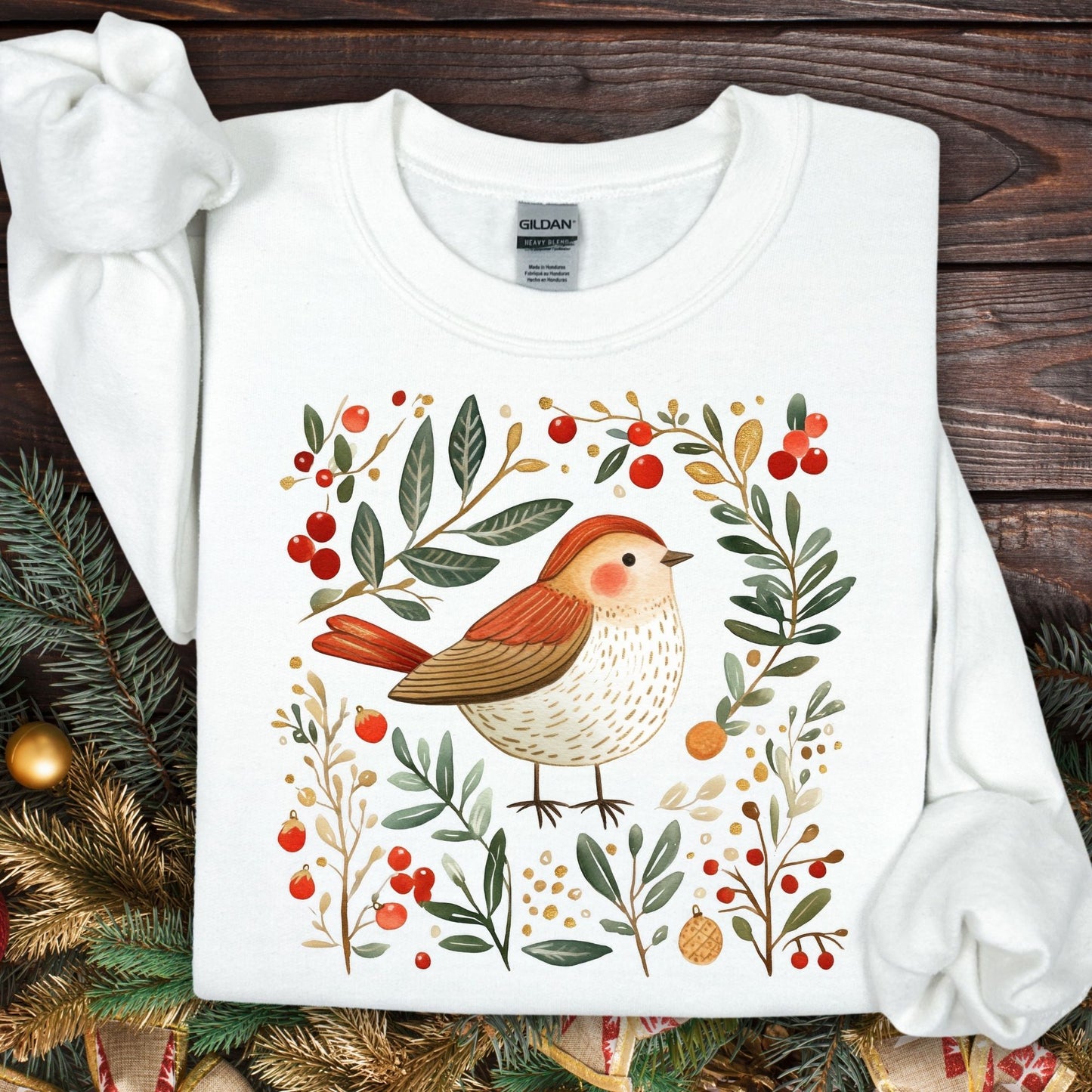 White Gildan sweatshirt with folk art sparrow, evergreens, holly, and ornaments.