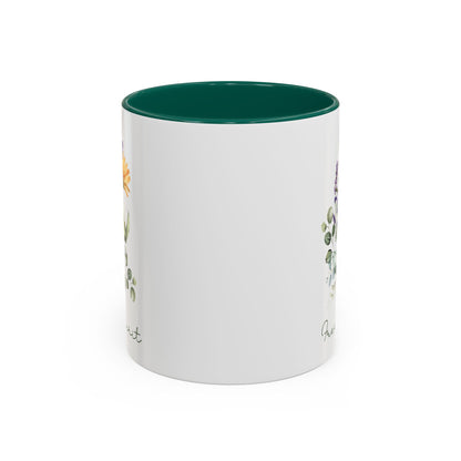 White ceramic mug with a dark green interior and handle, featuring watercolor wildflowers and "Free Spirit" script.