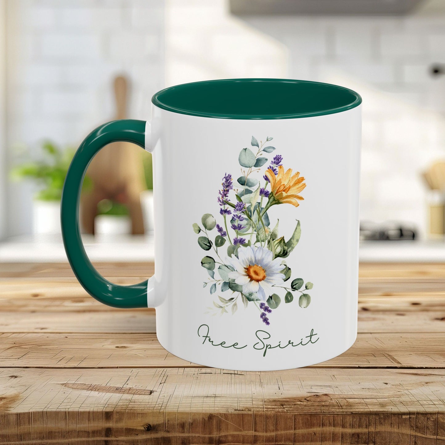 White ceramic mug with a green handle and interior, featuring watercolor wildflowers, eucalyptus, and "Free Spirit" script.