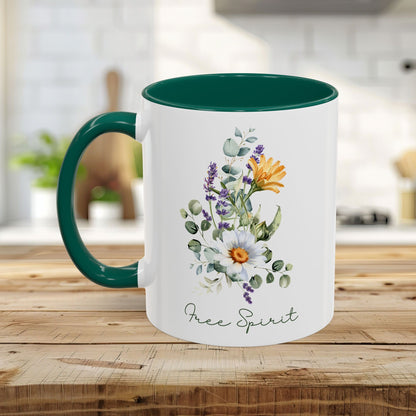 White ceramic mug with a green handle and interior, featuring watercolor wildflowers, eucalyptus, and "Free Spirit" script.