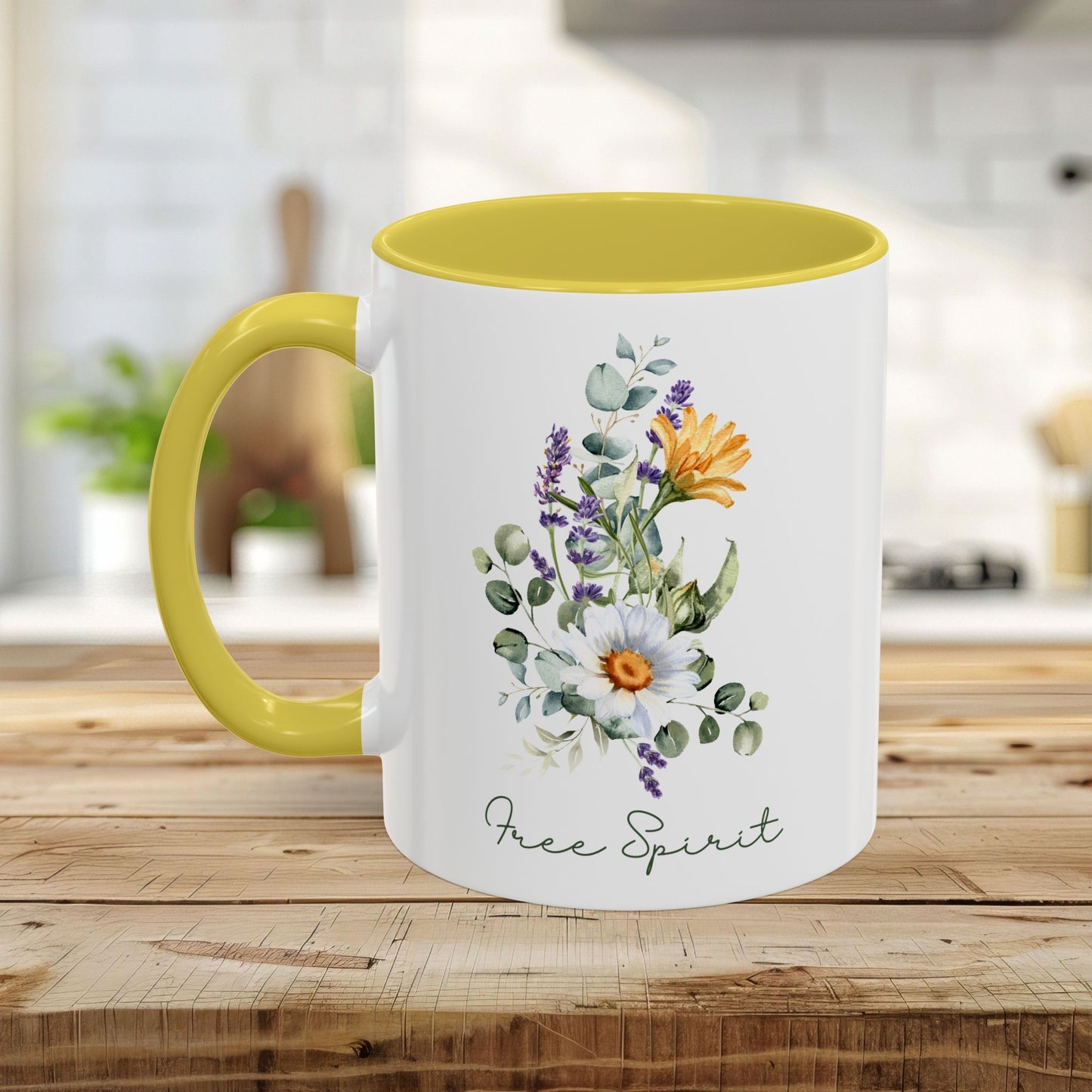 White ceramic mug with yellow handle and interior, featuring watercolor wildflowers, eucalyptus, and "Free Spirit" script.