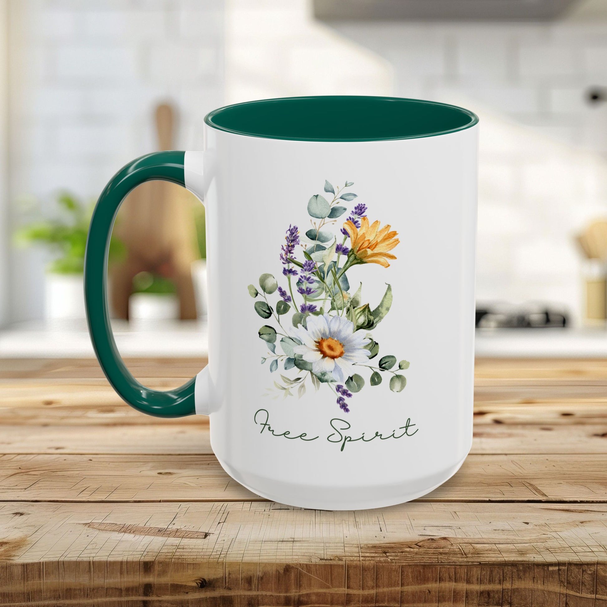 White ceramic mug with a dark green handle and interior, featuring watercolor wildflowers, eucalyptus, and "Free Spirit" script.