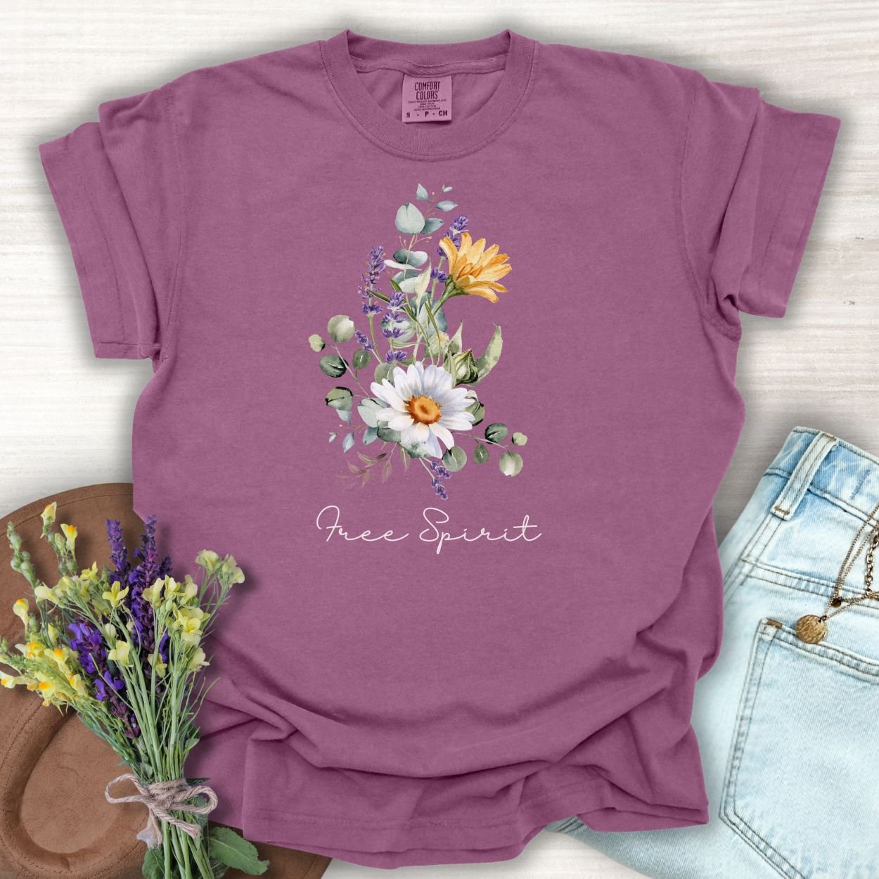 Berry S-sized cotton t-shirt with a "Free Spirit" botanical bouquet print of daisies, lavender, and eucalyptus.
