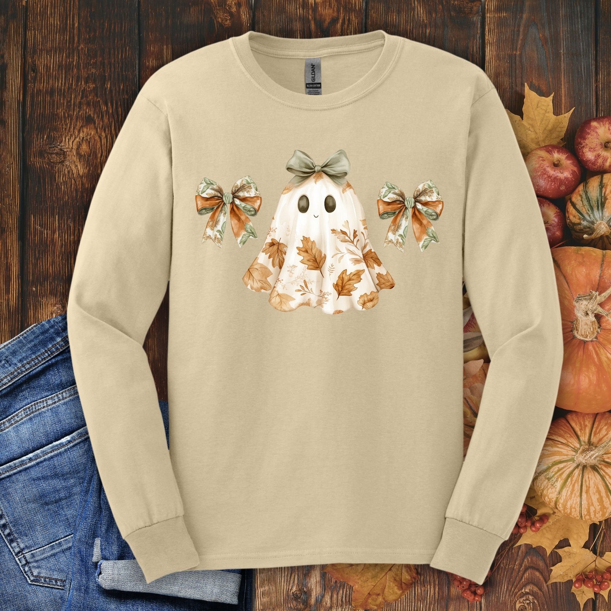 Sand long sleeve t-shirt with a friendly ghost, fall leaves, and bows design.