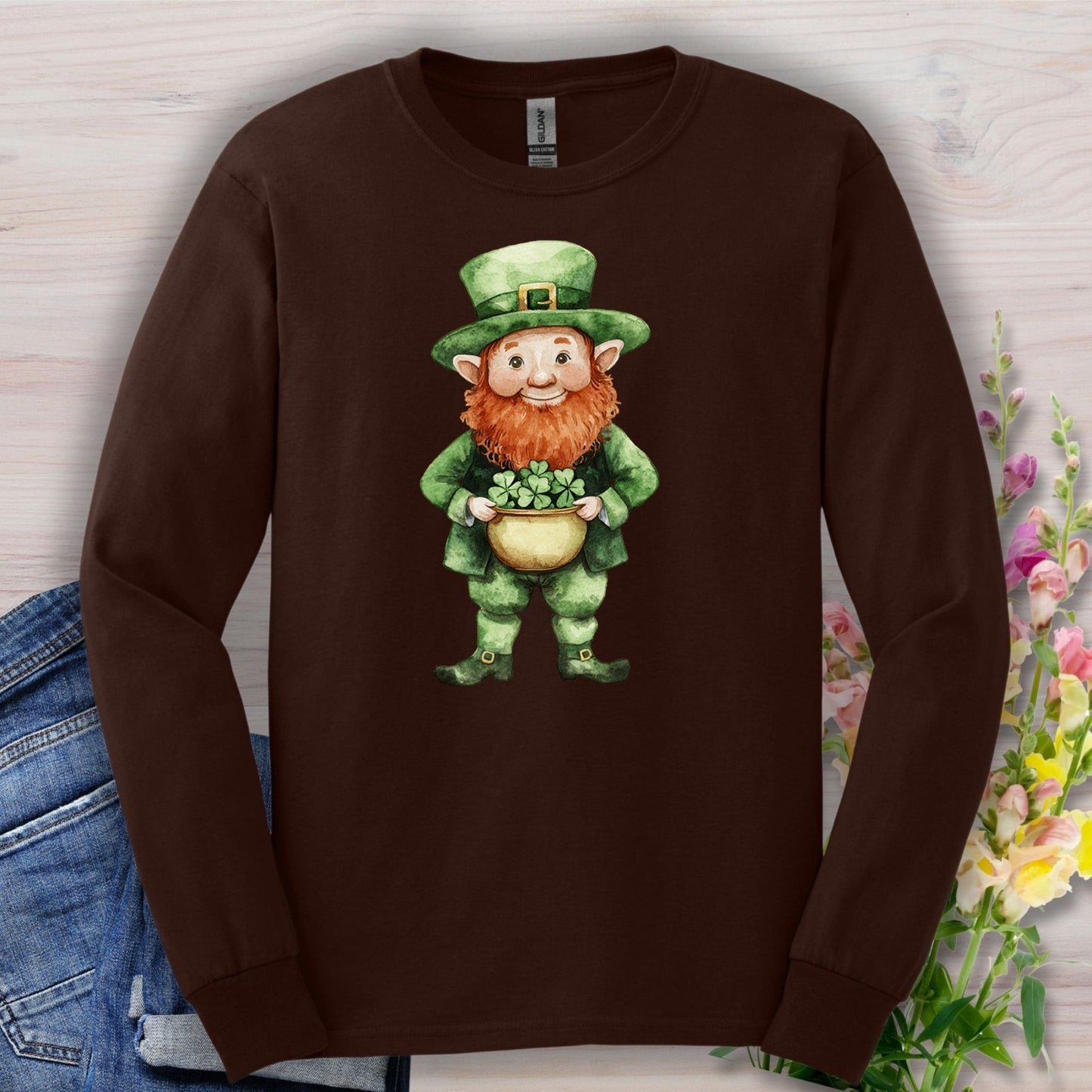 Dark chocolate long sleeve tee with a watercolor leprechaun holding a pot of shamrocks.