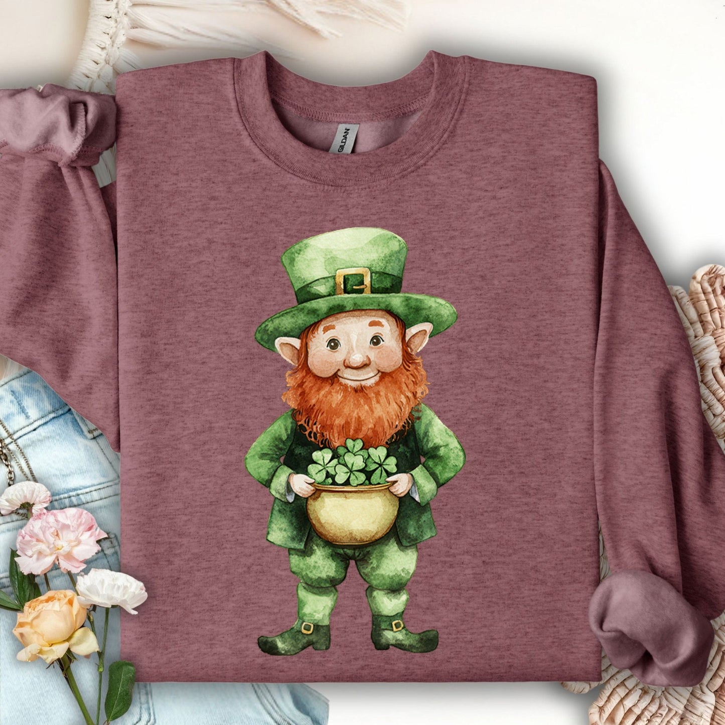 Heather maroon unisex sweatshirt with a watercolor leprechaun holding a pot of four-leaf clovers.